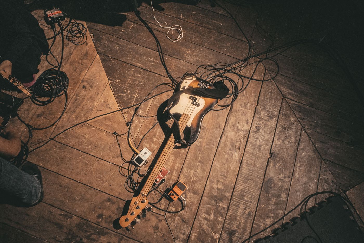 Guitarra elétrica apoiada no chão de madeira